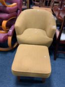 A modern upholstered tub chair and stool