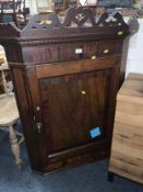 A Georgian oak cross banded corner cupboard together with An antique mahogany inlaid overmantel
