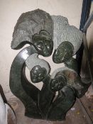 An artistic tribal stone type statue of four flowing heads - - H 90 cm, W 78 cm