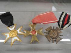 A Poland Knight cross medal and two other medals