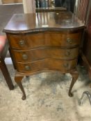 A small three drawer walnut bedside chest raised on cabriole legs