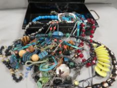 A tin document box of costume jewellery