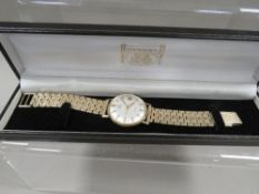 A mens 9ct gold Omega Geneva wristwatch on rolled gold bracelet