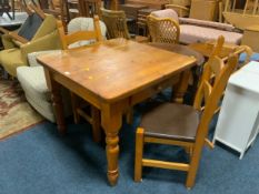 A small pine scrub top type table with two chairs