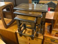 An oak nest of three tables together with an oak stool