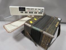 A Hohner squeeze box together with a Casio VL-Tone