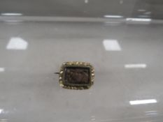 A 19th century mourning brooch set with woven hair