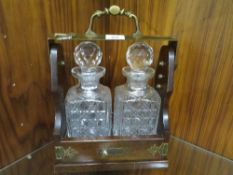 A two bottle tantalus with key