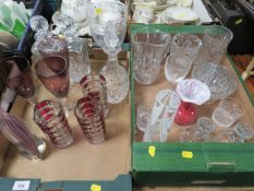 Two trays of assorted crystal and cut glass to include a studio glass end of day style bird