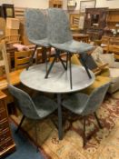 A modern circular show home style table with four chairs