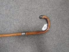 A hallmarked silver topped walking cane together with a silver topped bamboo example