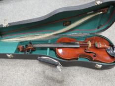 A vintage leather covered wooden cased violin with bow