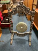 A carved oak gong on stand H 109 cm