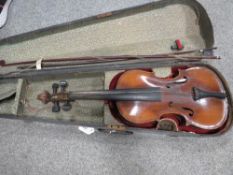 A vintage wooden cased violin with bow