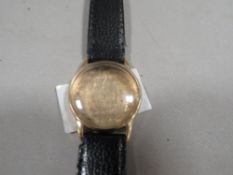 A hallmarked 9ct gold watch case on leather strap, overall weight approx. 16.7 g