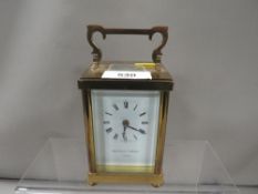 A small Matthew Norman carriage clock and key