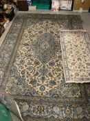 A large patterned woollen rug 304 x 204 cm together with a smaller wollen runner. (2)