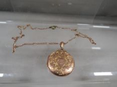 A rose gold chain stamped 9c on replacement brass clasp with a hallmarked 9 carat gold locket