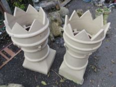 Two castellated chimney pots