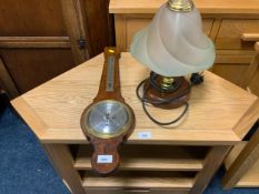 A small barometer and a table lamp. (2)