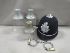 A vintage West Yorkshire police helmet, pair of handcuffs and 3 old police car bells