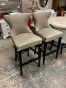 A pair of modern upholstered bar stools