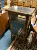 A bamboo and lacquered glazed single door cabinet together with two Eastern occasional tables