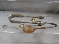 A small collection of hallmarked silver to include a pair of fiddle pattern sugar tongs with early
