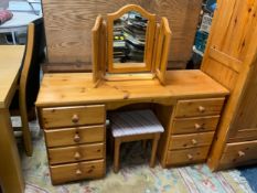 A honey pine dressing table with triple mirror and stool
