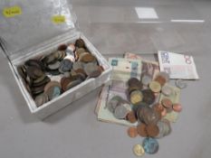 A box of world coins and banknotes
