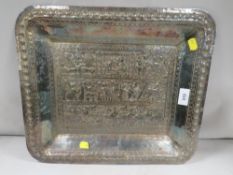 A sub-continental white metal serving tray decorated with figures and woodland animals