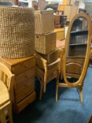 A modern pine effect cheval mirror a honey pine chest and a quantity of wicker chairs and baskets