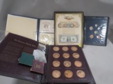 A quantity of collectors coins to include the Thomason Medallic Bible by Franklin Mint