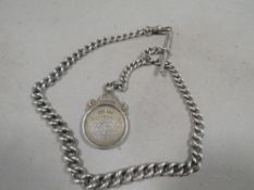 An antique hallmarked silver gents pocket watch Albert chain with gold and silver fob medal