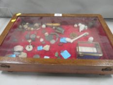 A display case containing antiquarian finds to include coins from the 1600's, Celtic coin dated 20-