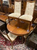 A mid-century teak extending table with six chairs