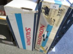 Two boxed pairs of Salomon ski boots