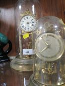 A glass dome clock together with a plastic dome clock (2)