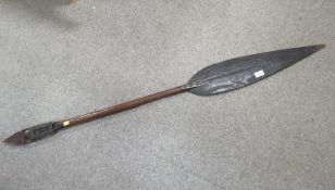 A Polynesian carved wood ceremonial paddle spear, with carved decoration