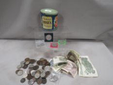 A tin of assorted coins and British notes