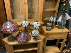 A collection of seven assorted Tiffany style table lamps and shades to include one spare shade