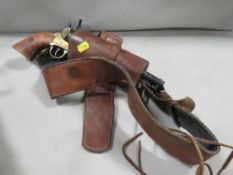 A re-enactment Western style pistol together with a leather holster