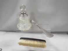 A silver mounted cut glass scent bottle, silver handle shoe horn and a clothes brush