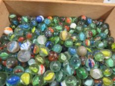 A wooden box containing old marbles