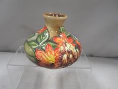 A squat Moorcroft floral vase marked with a silver line