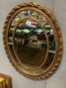 A modern oval gilt sectional mirror
