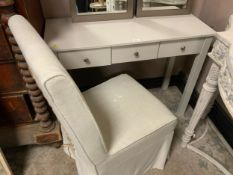 A modern three drawer side table together with an upholstered chair