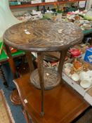 A small Eastern style carved occasional table