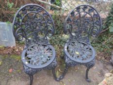 Two cast iron garden chairs