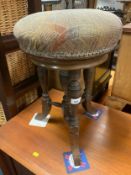 An antique mahogany revolving piano stool